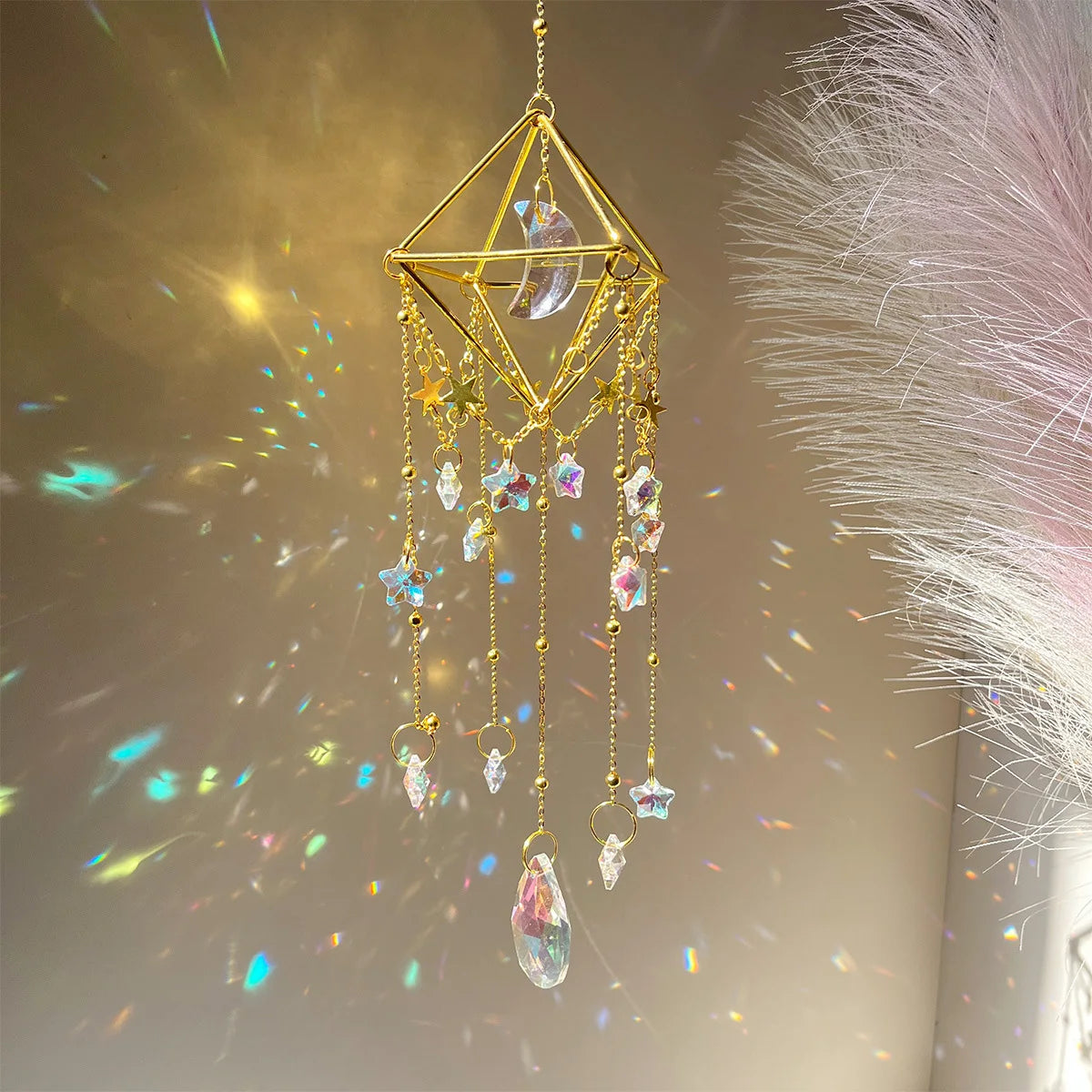A golden geometric crystal hanging suncatcher decoration with dangling clear and colored crystals.