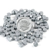 A pile of silver-gray transparent wax sealing beads for custom stamps.
