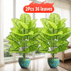 Two artificial floor plants with green leaves in blue pots displayed indoors near a window.