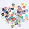 A collection of heart-shaped amethyst crystal stones in various colors and shades.