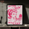 A framed print featuring a pink illustration of a woman with a dramatic hairstyle and text that reads Better Late Than Ugly.