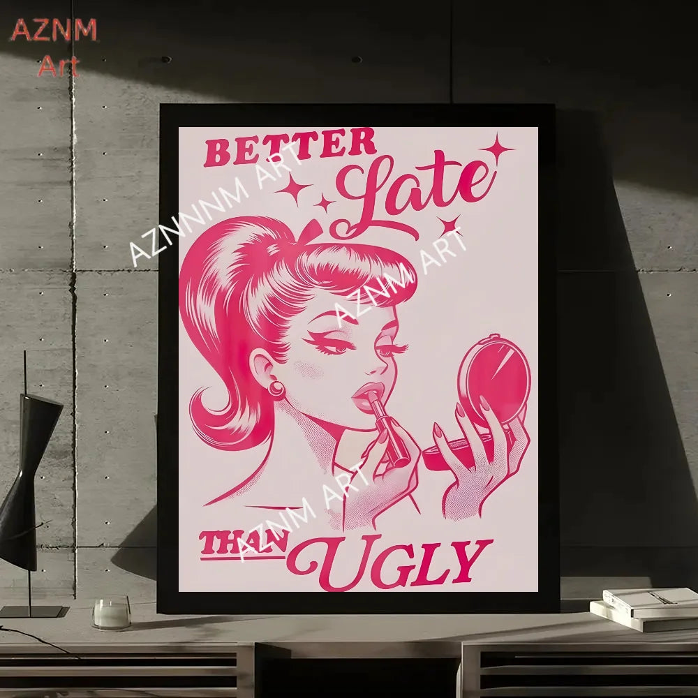 A framed print featuring a pink illustration of a woman with a dramatic hairstyle and text that reads Better Late Than Ugly.