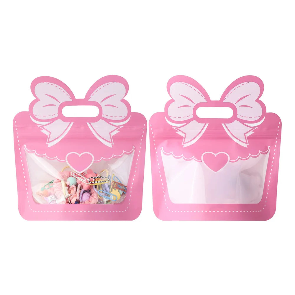 A pink bow-themed birthday party supplies set featuring clear plastic bags with decorative bows.