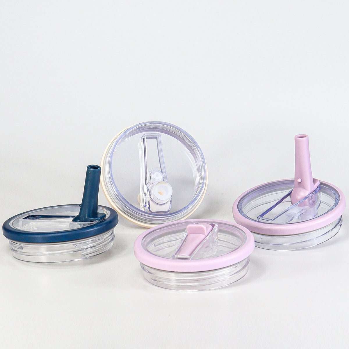 Replacement tumbler lid for 40 oz cups with silicone and plastic components in blue and pink colors