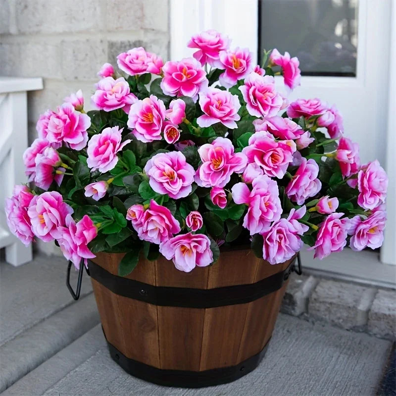 A potted artificial red azalea bush with vibrant pink flowers displayed outdoors.