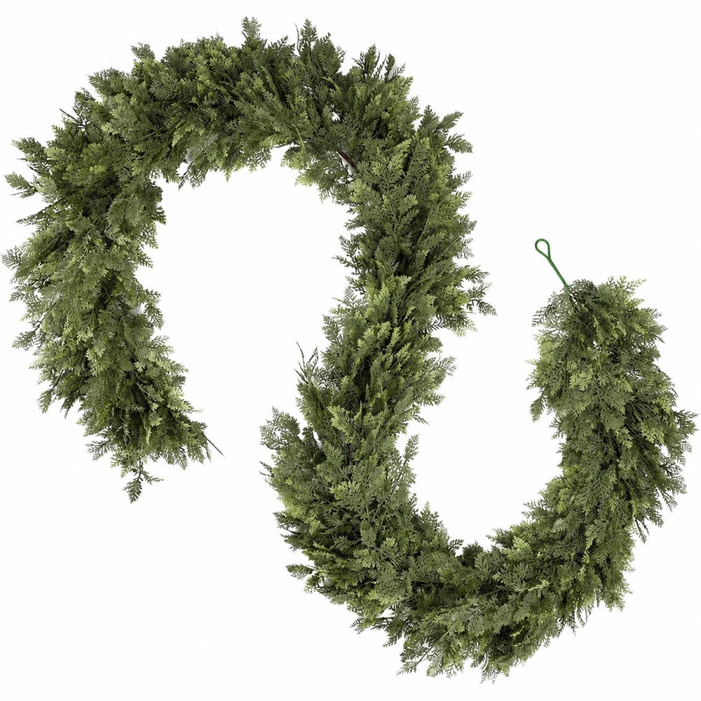 A green artificial cedar garland shaped into a decorative hook or loop for holiday decor.