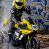 A yellow cartoon plush helmet cover is displayed on a motorcycle.