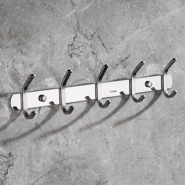 A set of six polished 304 stainless steel wall-mounted hooks mounted on a gray concrete surface.