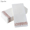 A stack of white paper dinner napkins with rose gold trim, showing a close-up view.