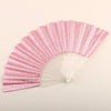 A pink glitter folding fan with transparent ribs shown in a fan shape.