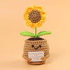 Handmade crochet sunflower desk companion with a smiling face made of yarn.