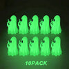 A pack of ten glowing green ghost figurines with playful hands against a dark background.