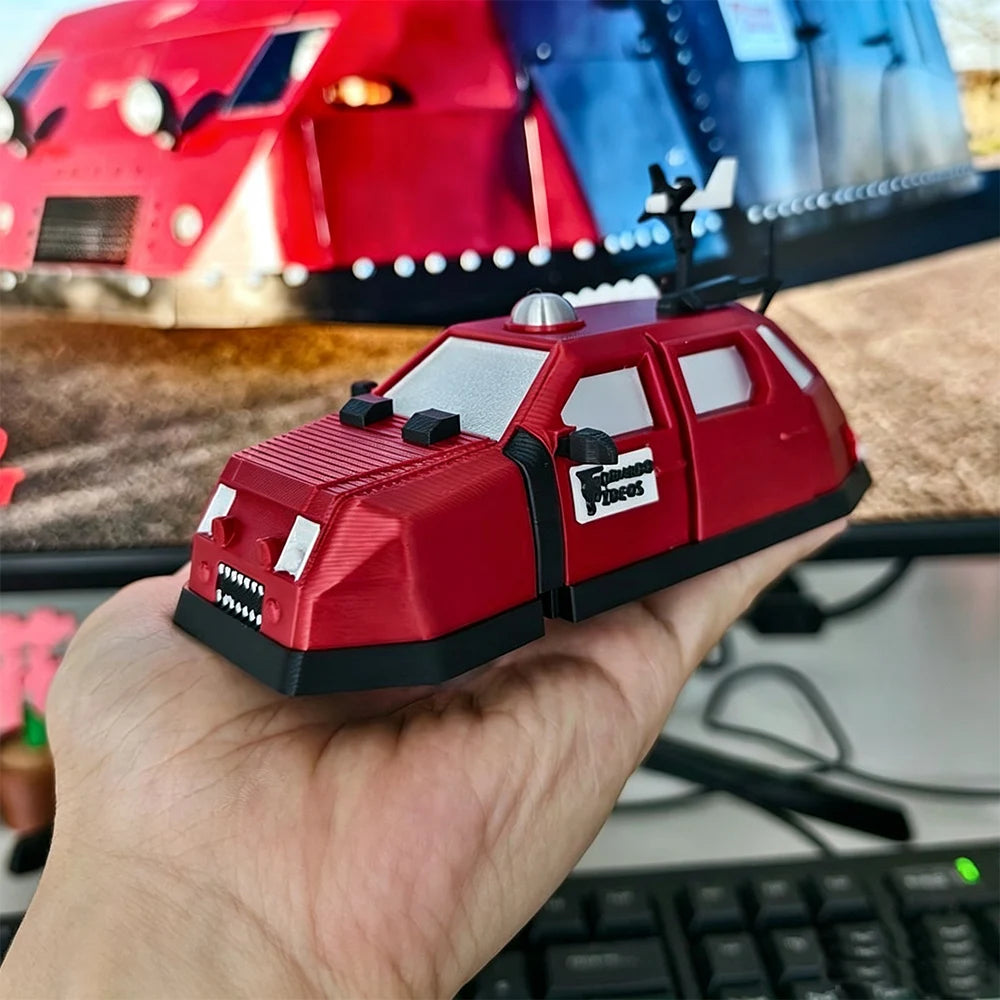 A hand holds a red armored car model, the Storm Chaser Tornado Interceptor, against a blurred background of other vehicles.