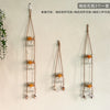 Three sets of hanging glass terrariums with small orange flowers and leaves