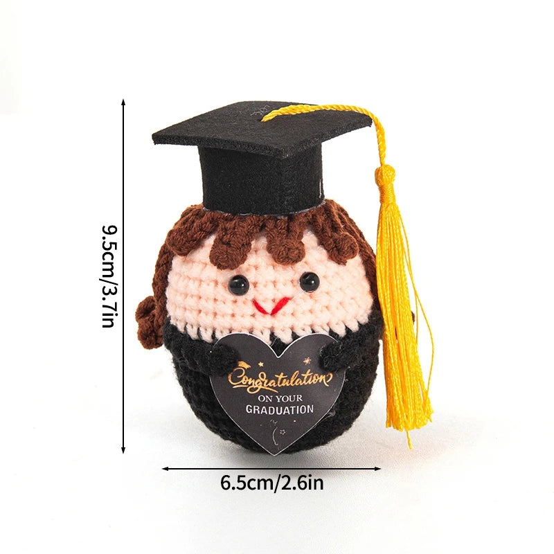 Handmade crochet potato doll with a graduation cap and inspirational slogan on the front