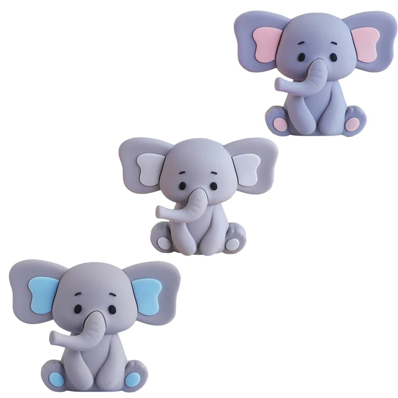 Three stylized elephant figures in light purple and blue for a birthday party cake topper