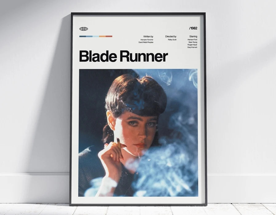 A framed poster of Blade Runner featuring a close-up portrait of a woman with smoke effects.