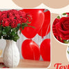 A bouquet of red velvet artificial roses with bendable stems displayed on a wooden table.