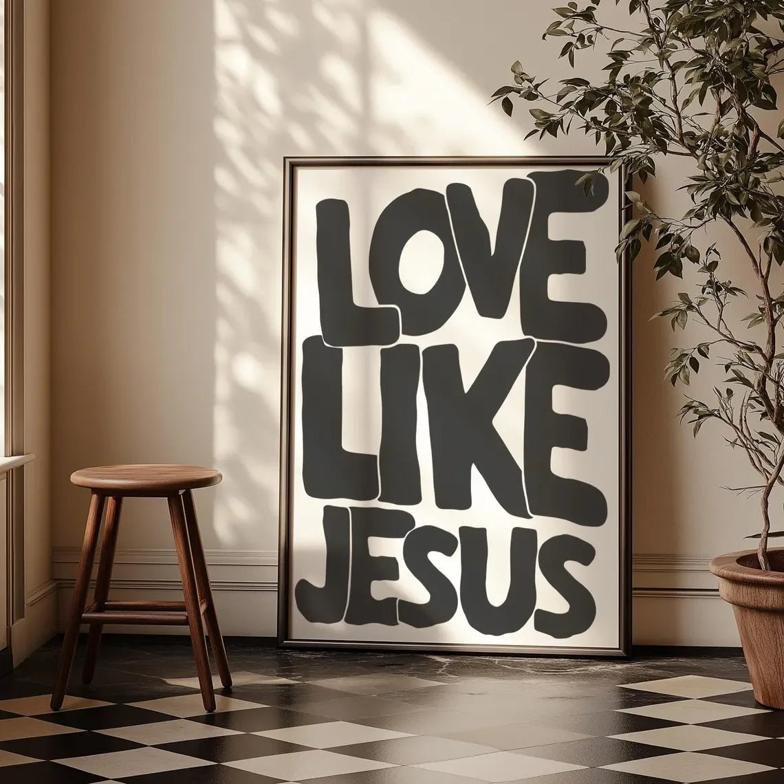 Black and white text art on a canvas print featuring the phrase Love Like Jesus framed in gold.