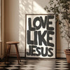 Black and white text art on a canvas print featuring the phrase Love Like Jesus framed in gold.