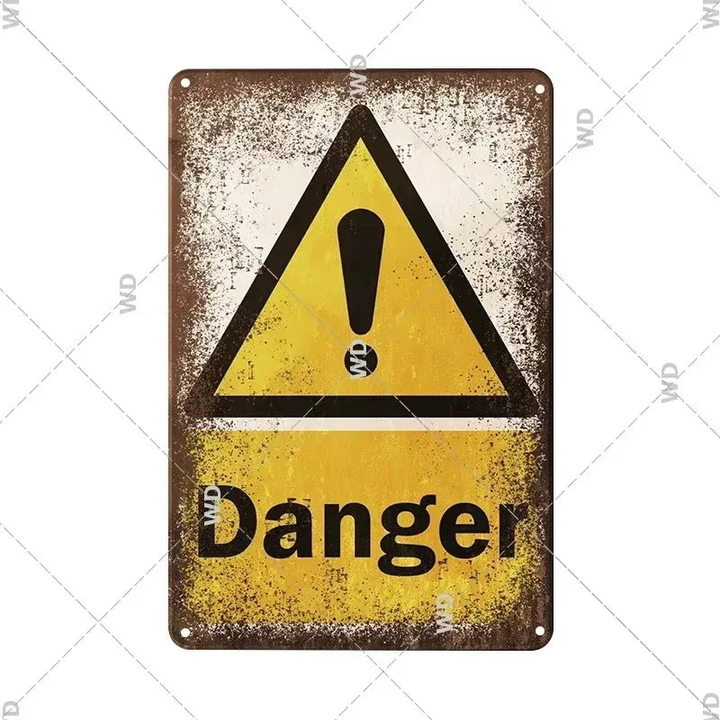 A vintage metal sign with a yellow triangle warning symbol and the word Danger on it.