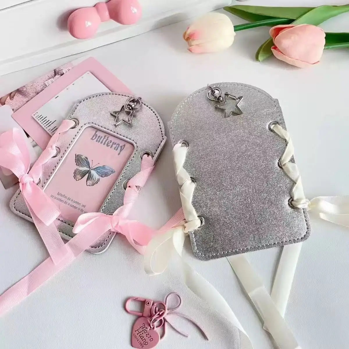 Silver felt card holder with a butterfly design and white ribbon keychain