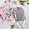 Silver felt card holder with a butterfly design and white ribbon keychain