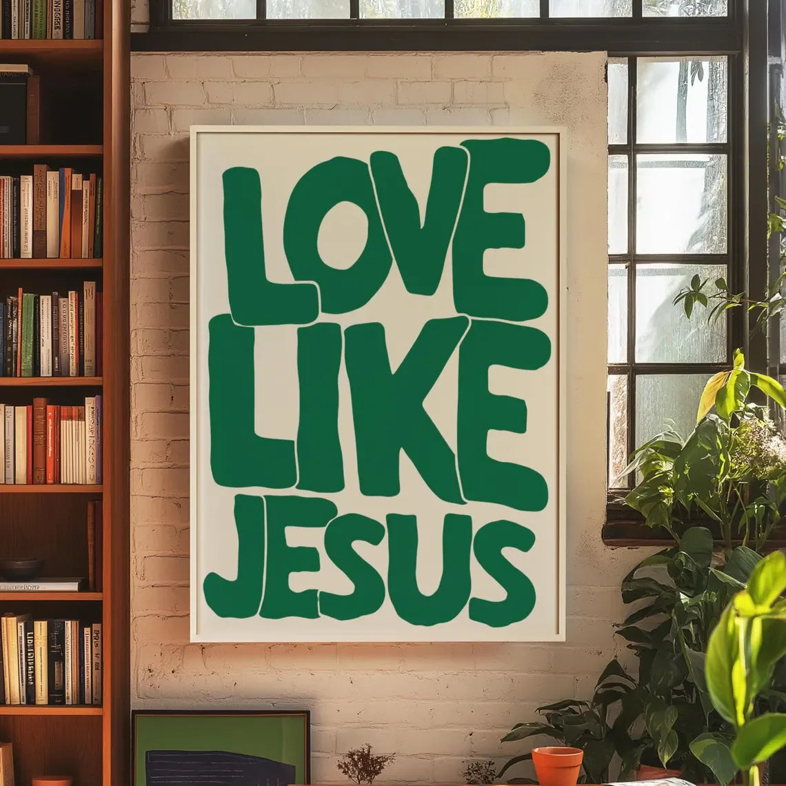 A framed canvas print featuring the text Love Like Jesus in large, green, block letters on a white background.