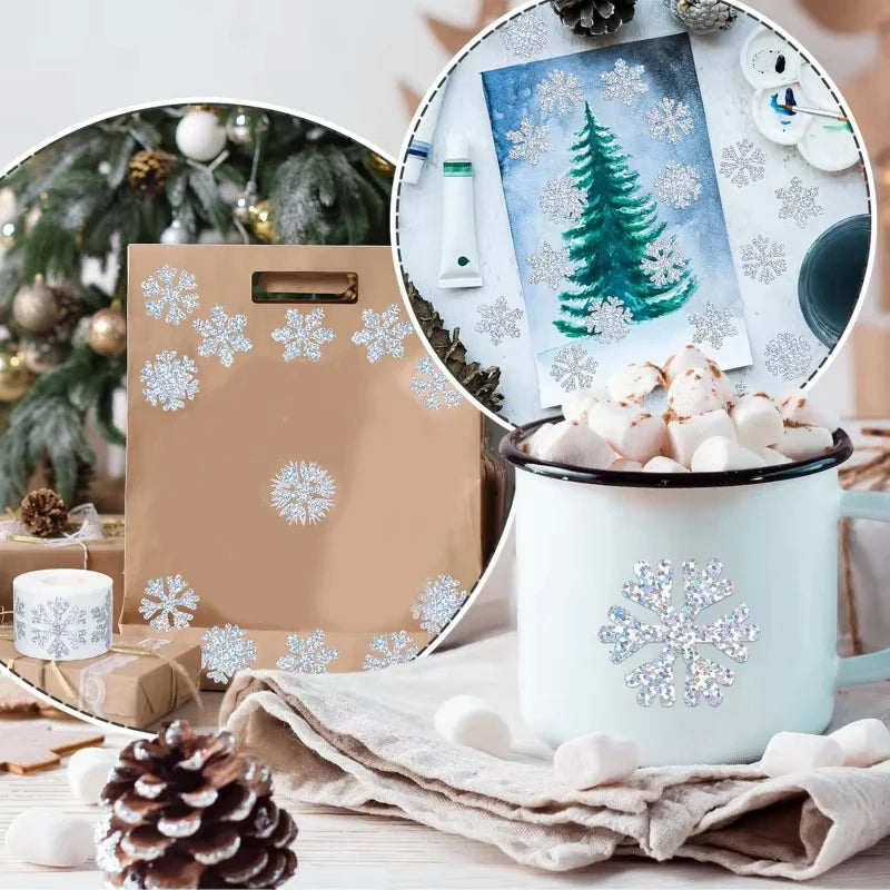 A white mug filled with snow and glittery laser Christmas snowflake stickers displayed next to a wooden gift bag.