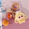 A yellow fluffy heart plush charm with pink accents and a gold-colored keyring.