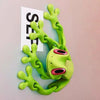 A bright lime green, movable 3D printed tree frog ornament with large eyes and limbs.