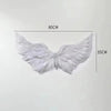 White angel feather wings costume prop with adjustable straps, measuring 80cm by 35cm.