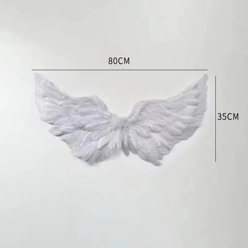 White angel feather wings costume prop with adjustable straps, measuring 80cm by 35cm.