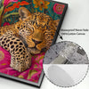 Canvas print featuring a sleeping leopard with floral patterns, displayed in a black frame.