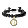 Handmade zodiac beaded bracelet with natural black stone featuring a gold charm of the Libra symbol