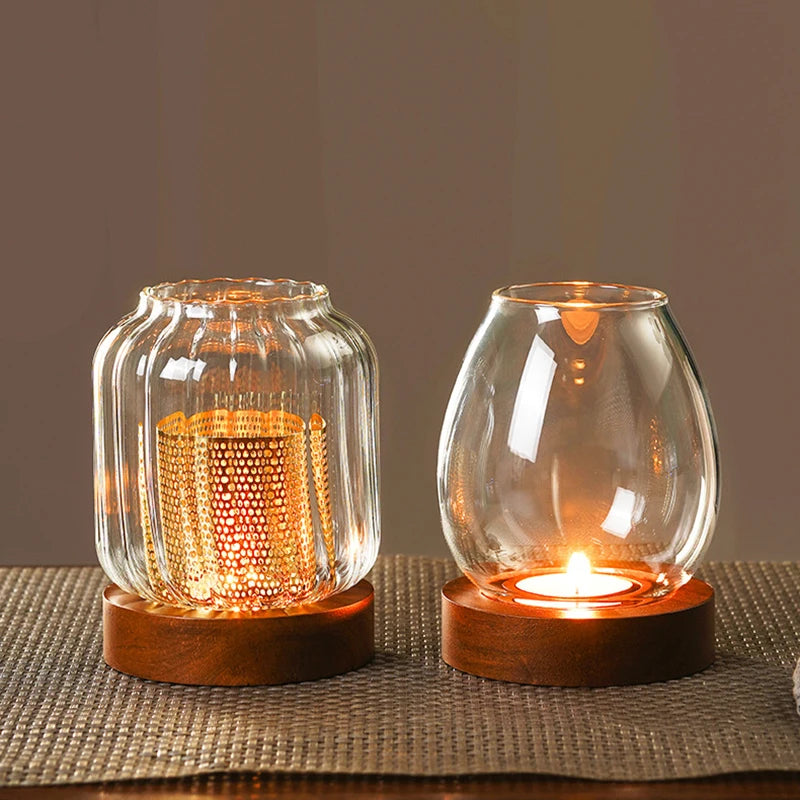 A vintage wooden candle lantern with a glass cover glowing warmly on a textured surface.