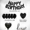A kit of black birthday balloons including foil letters, heart-shaped balloons, and black rose petals.