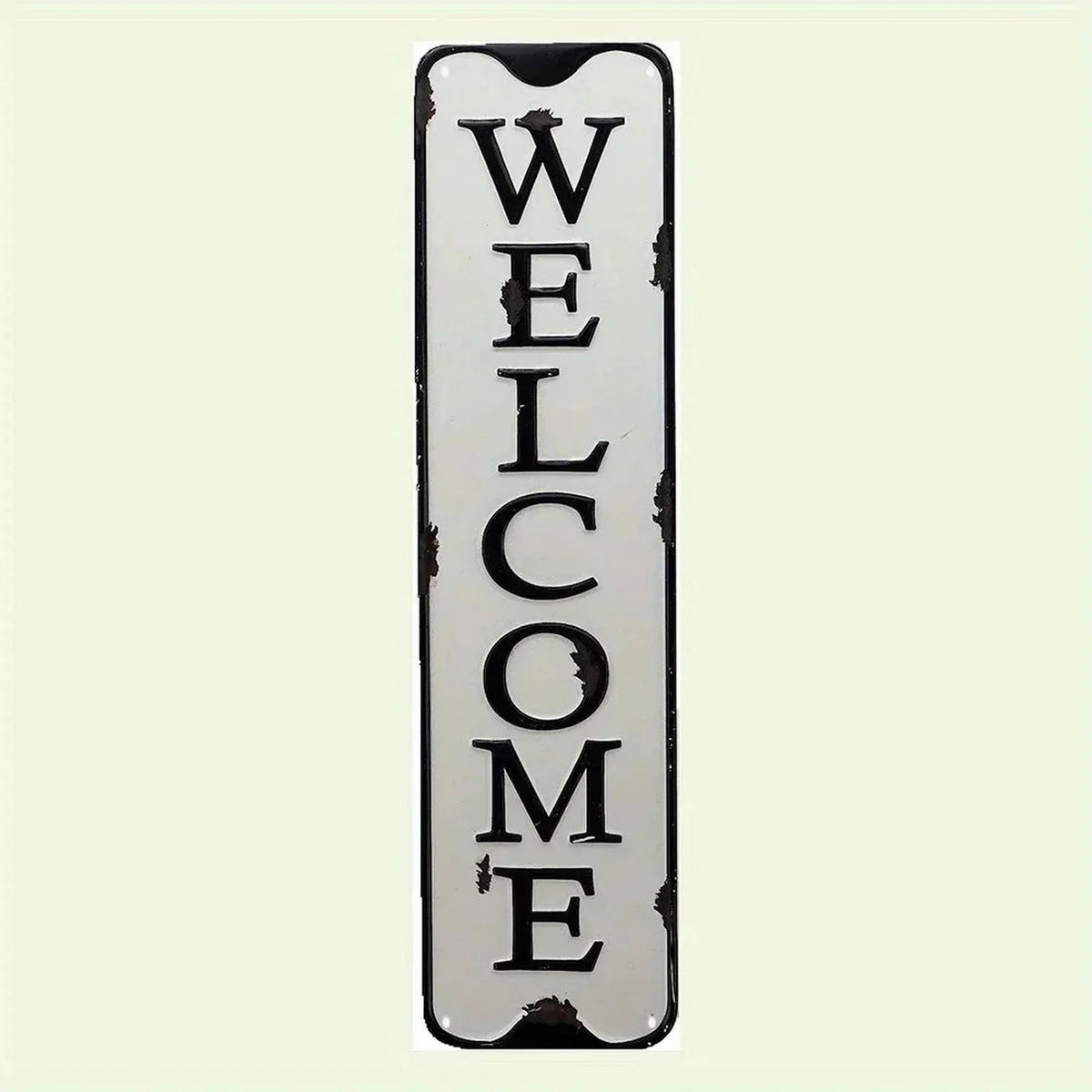 A vertical vintage metal street sign with the word WELCOME carved into it.