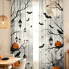 Gray curtains featuring black tree branches, bats, and pumpkins for a spooky Halloween theme