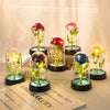A collection of glass domes displaying preserved roses and greenery on a white surface.