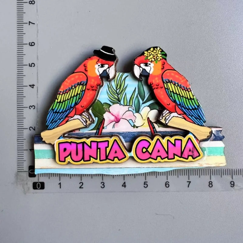 A colorful wooden fridge magnet featuring a toucan bird and tropical leaves with the text PUNTA CANA