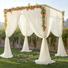A sheer white chiffon backdrop curtain decorated with floral vines for a wedding or event setting.