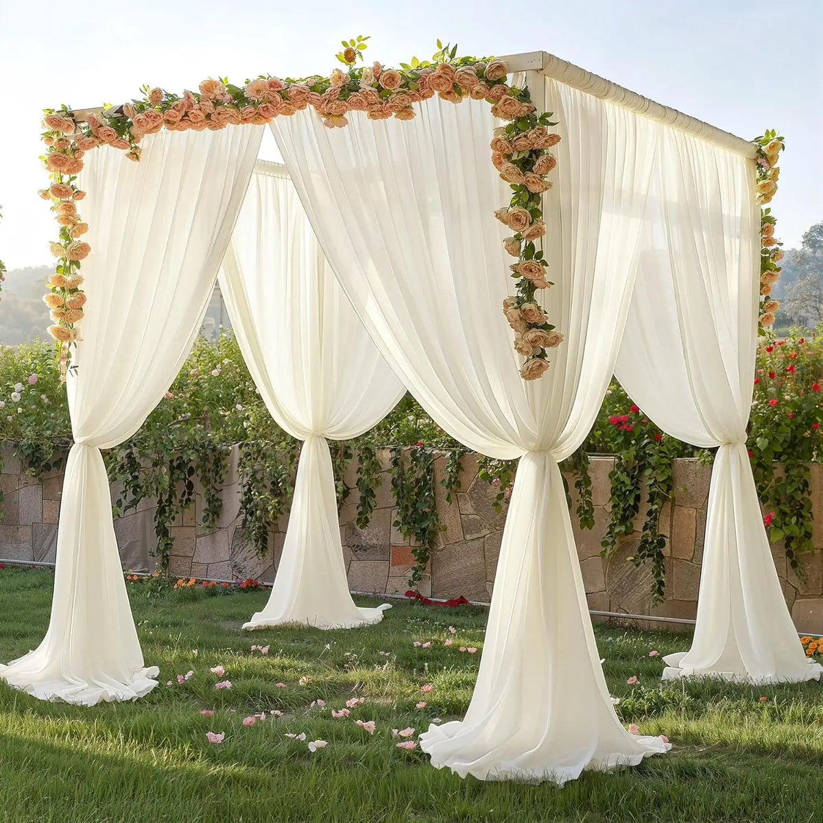 A sheer white chiffon backdrop curtain decorated with floral vines for a wedding or event setting.