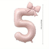 A large pink foil number balloon shaped like the number 5 with a bow.