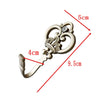 A pair of vintage crown curtain hooks with a decorative design and a small rhinestone detail.
