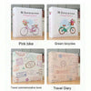 A set of three photo albums featuring a pink bike, green bicycles, and a travel diary.