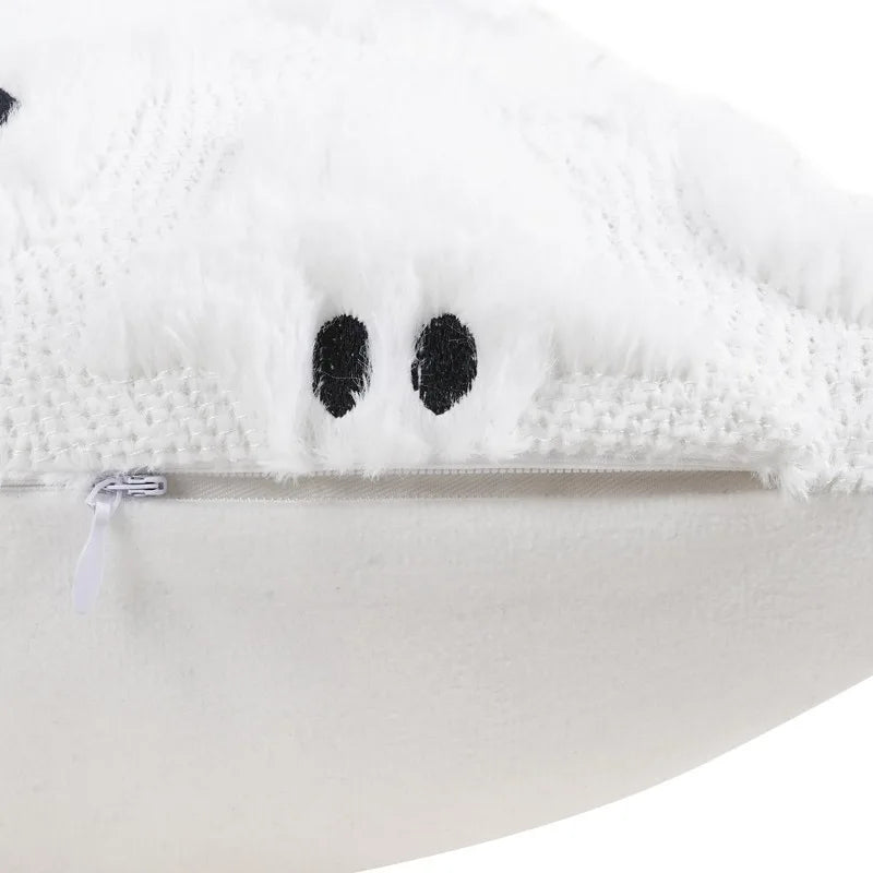 White plush pumpkin ghost pillow cover with black eyes and a zipper detail