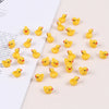 A collection of small yellow resin duck figurines scattered on a white background.