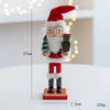 A handcrafted wooden nutcracker soldier figurine dressed as Santa Claus with a red hat and beard.