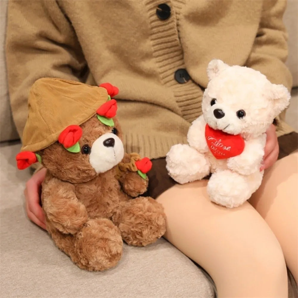 A fluffy brown bear plush toy with a straw hat and red roses is held by a person wearing a beige jacket.